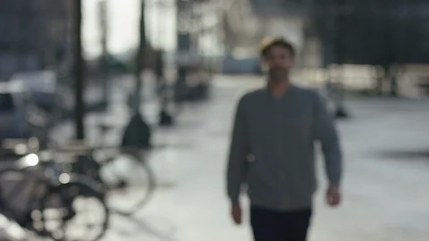 Middle aged attractive man walking towards the camera and smiling; place for  Stock Footage 97827145