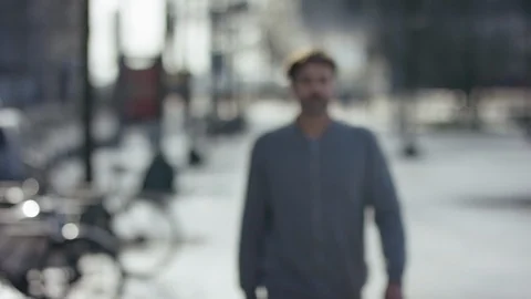Middle aged attractive man walking towards the camera in urban city; place fo Stock Footage 97832196