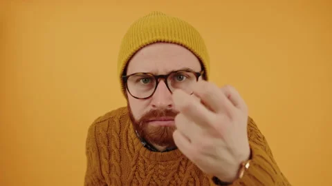 Middle-aged bearded hipster man knocking at the screen and suspiciously looking Stock Footage 171486400