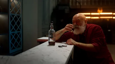Middle-aged bearded man drinks liquor before leaving bar, drunk driving concept Stock Footage 342520377