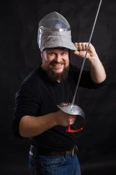 Middle aged bearded man with epee and helmet Stock Photos