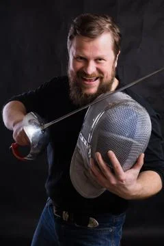 Middle aged bearded man with epee and helmet Stock Photos
