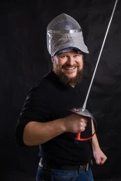 Middle aged bearded man with epee and helmet Stock Photos