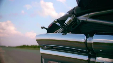 Middle-aged biker with beard sits by motorcycle at sunset Stock Footage 154814978