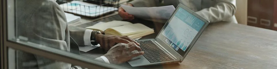 Middle Aged Black Man Analyzing Financial Data on Laptop during Business Meeting Stock Photos