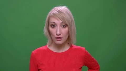 Middle-aged blonde short-haired woman flirting with camera showing her lips Stock Footage 108678309