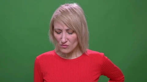 Middle-aged blonde short-haired model turns head negatively to refuse isolated Video stock 108678520