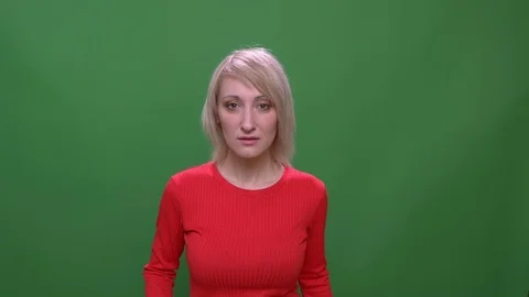 Middle-aged blonde short-haired model waves hand being very surprised isolated Video stock 108679711