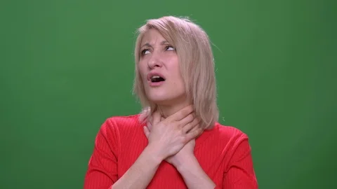 Middle-aged blonde short-haired model suffers from flu and sore throat isolated Stock Footage 108680467