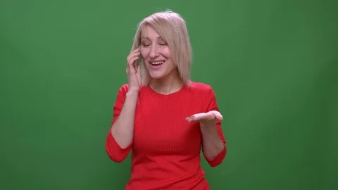 Middle-aged blonde short-haired businesswoman talks on smartphone gladly Stock Footage 108680891