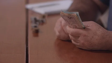 A middle-aged Brazilian man counts the money to pay the house bills Stock-Footage 93908758