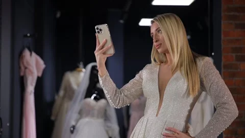A middle-aged bride of American appearance takes a selfie in a luxurious white Stock Footage 304959339
