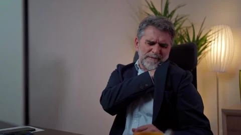 Middle-aged business man is suffering from shoulder pain in the office Stock Footage 268328443