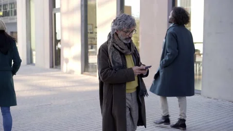 Middle-aged Business man is Using a Smartphone on a Street in Downtown. Old man Stock Footage 225498865