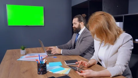 Middle-aged business partners working using devices in office Stock Footage 114789544