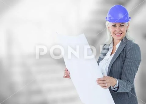 Middle aged business woman against blurry grey stairs Stock Photos