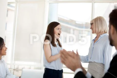 Middle-aged business woman handshake excited employee congratulat Stock Photos