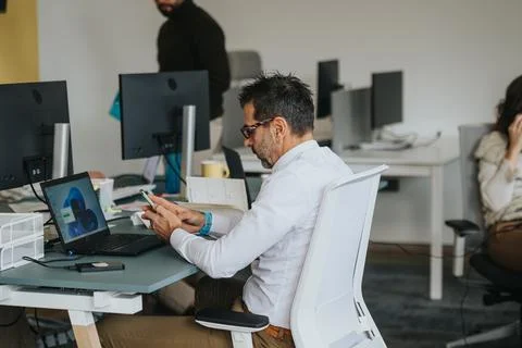 Middle-aged businessman analyzing data for market research and strategizing Stock Photos