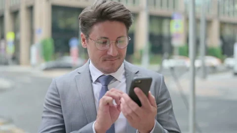 Middle Aged Businessman Browsing Internet on Smartphone 스톡 동영상 158797063