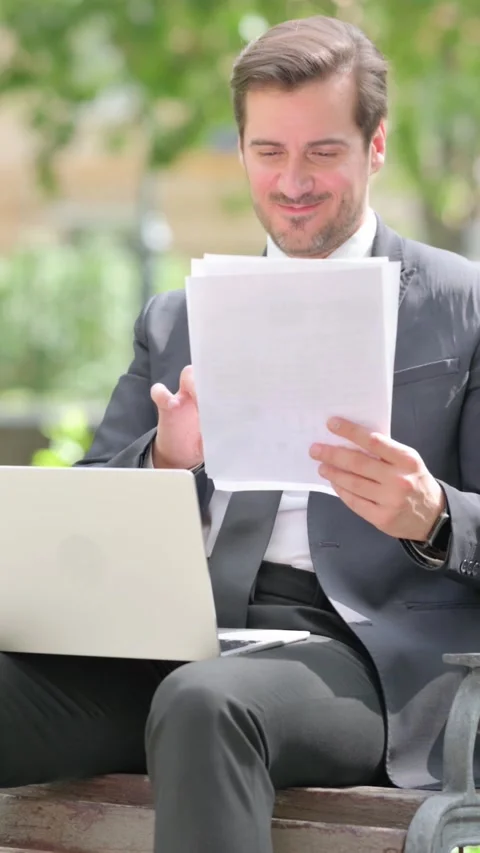 Middle Aged Businessman Celebrating with Documents and Laptop Outdoor Video stock 319971160
