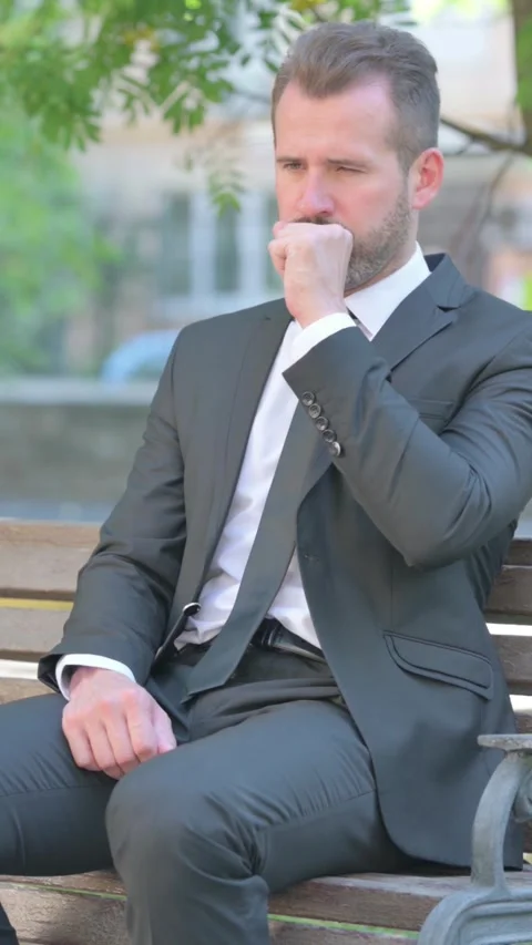 Middle Aged Businessman Coughing while Sitting Outdoor on Bench, Vertical Video Stock Footage 319042482