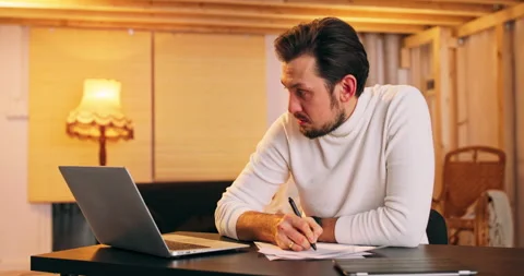 Middle aged businessman develops business project, looks on laptop, makes Vídeo Stock 146037247