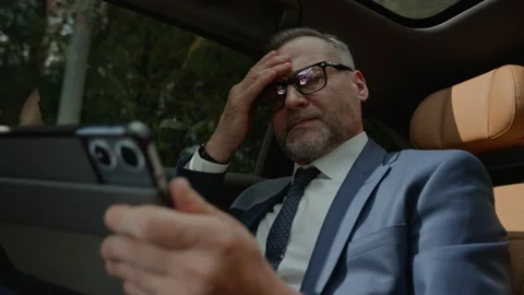 Middle Aged Businessman Feeling Stressed While Using Tablet in Car Stock Footage 343389933