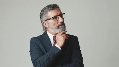Middle aged businessman hand props chin, isolated on gray background Vídeo Stock 252502835