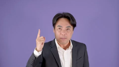 Middle Aged Businessman Reacts With Surprised Pointing Gesture On Purple Stock Footage 323496953