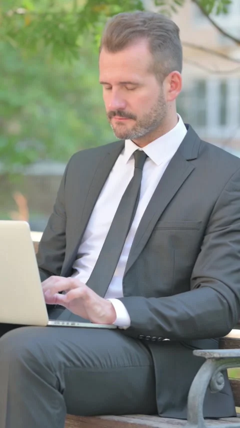 Middle Aged Businessman Smiling at Camera while Using Laptop Outdoor, Vertical Stock-Footage 319044773