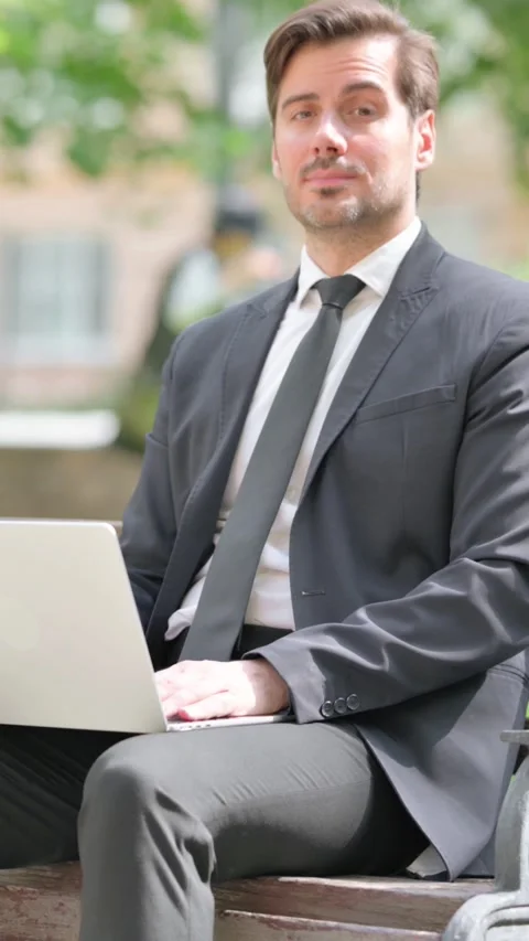 Middle Aged Businessman Smiling at Camera while Using Laptop Outdoor Video stock 319971238