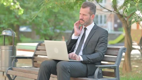 Middle Aged Businessman with Toothache Using Laptop Outdoor Stock Footage 287924954