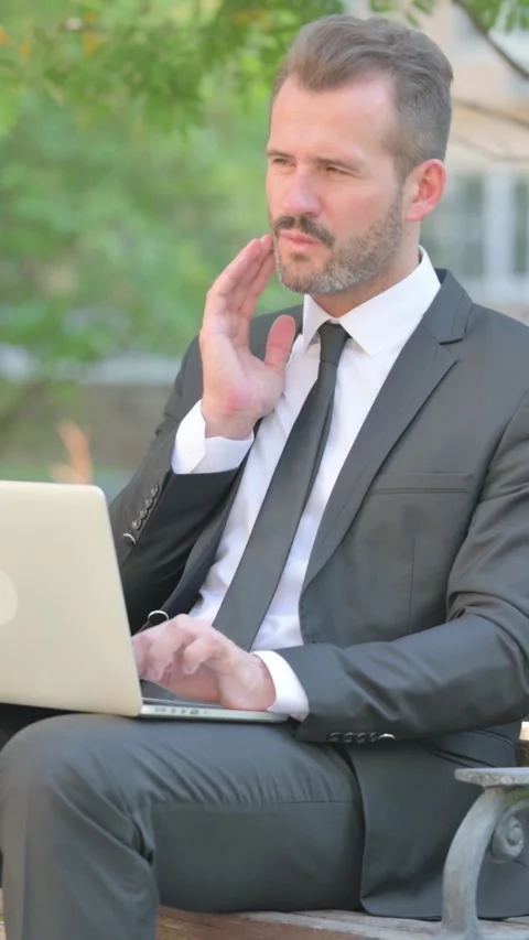 Middle Aged Businessman with Toothache Using Laptop Outdoor, Vertical Video Stock Footage 319044463