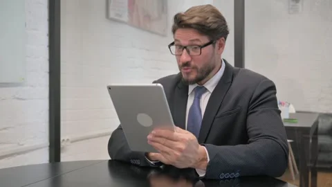 Middle Aged Businessman Using Digital Tablet for Video Chat Video stock 310164216