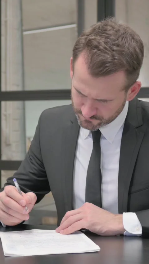 Middle Aged Businessman Working on Documents, vertical video Stock Footage 324795167