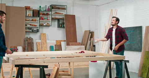 Middle - aged carpenters build a solid wood wall in a carpentry workshop Stock Footage 144090890