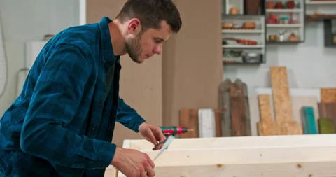 Middle - aged carpenters build a solid wood wall in a carpentry workshop. The Stock Footage 144091324