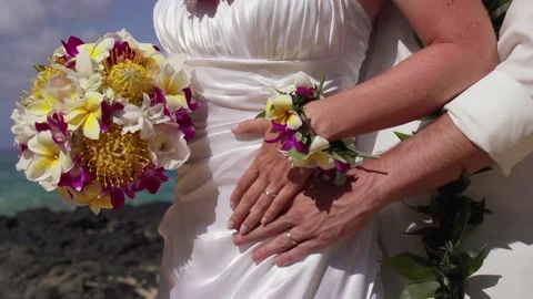 Middle aged Caucasian couple display wedding rings during their Hawaiian wedding Stock Footage 136266830