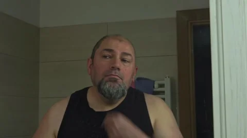 Middle-Aged Caucasian Guy Using Electric Razor for Beard Trim Stock Footage 337164623