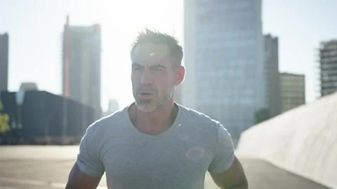 Middle-aged Caucasian man running alone in an urban area. Disciplined male Stock Footage 275206695