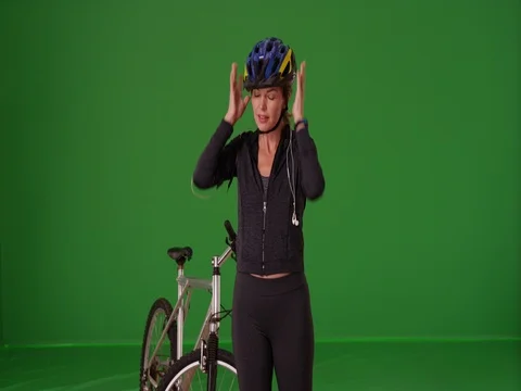 Middle aged Caucasian woman preparing to ride bike on green screen Stock Footage