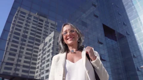 Middle-aged confident, focused and powerful business woman looking at camera Stock Footage 220431448