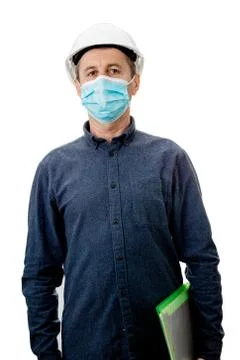Middle aged Contractor or architect  holding a notepad, wearing protective he Stock Photos