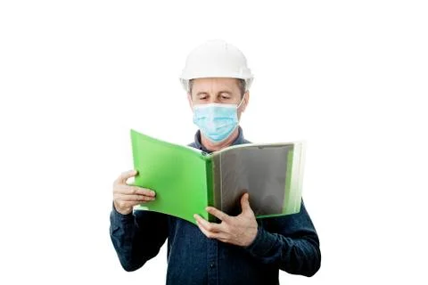 Middle aged Contractor or architect holding a notepad, wearing protective helmet Stock Photos