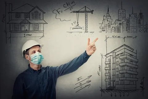 Middle aged contractor or architect wearing protective helmet and face mask a Stock Photos