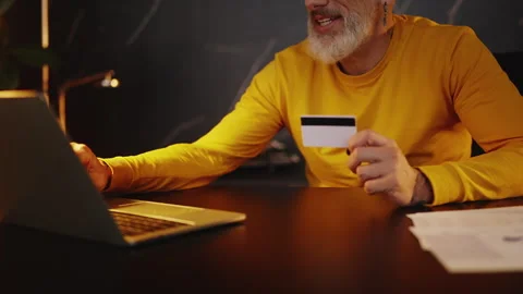 Middle-aged corporate executive using a credit card to make a payment on laptop Stock Footage 340902695
