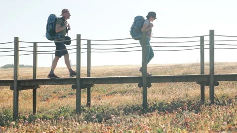 Middle-aged couple with backpacks walking together in Portugal on the Camino Por Video stock 319926243
