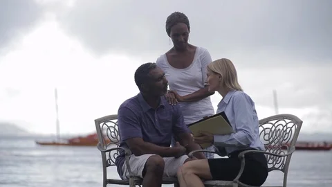 Middle-aged couple being interviewed by the sea. 스톡 동영상 88369644