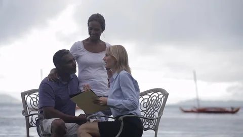 Middle-aged couple being interviewed by the sea. 스톡 동영상 88369656