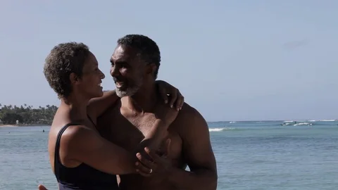 Middle-aged couple embracing on a beach. Видео 88367490